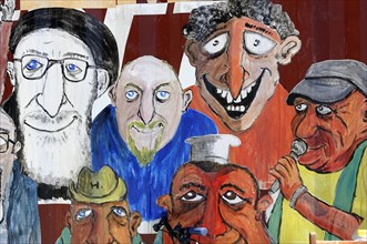 Marseille art bazaar, wall painting with colourful caricatures of various facial expressions,