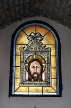 Castillo de Santa Catalina in Jaen, artistic stained glass window with a portrait of Jesus,