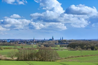 View over fields and old town with churches of the Hanseatic City of Luebeck, Schleswig-Holstein,