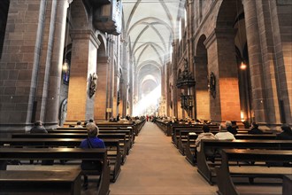Speyer Cathedral, rays of light fall on visitors in the interior of Worms Cathedral, Speyer