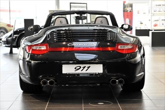 Rear view of a black Porsche Carrera 4S Cabriolet with the number 911, Schwaebisch Gmuend,