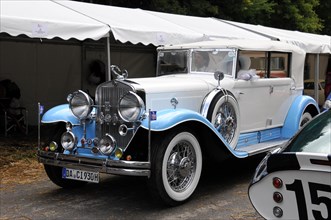 Cadillac Imperial Phaeton, built in 1930, A white vintage car with blue accents and chrome details