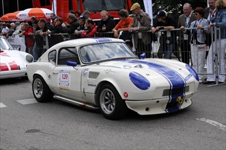 A grey vintage sports car with blue stripes takes part in a racing event, SOLITUDE REVIVAL 2011,