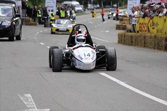 A formula racing car drives on a closed-off track during a street race, SOLITUDE REVIVAL 2011,
