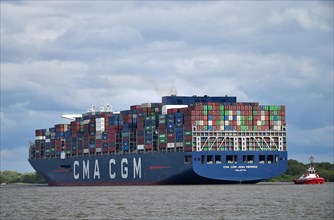 Container ship CMA CGM Jean Mermoz sailing in the Elbe to the port of Hamburg, Germany, Europe