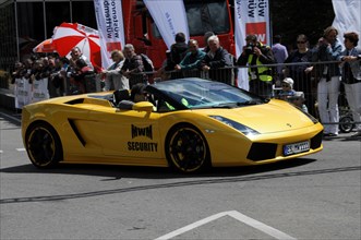 A Lamborghini convertible drives in front of spectators at a motorsport event, SOLITUDE REVIVAL