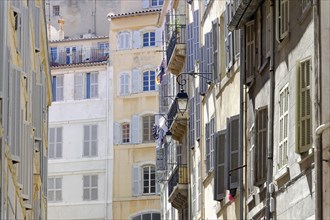 Marseille, Sun-drenched narrow alleyway with traditional buildings and shutters, Marseille,