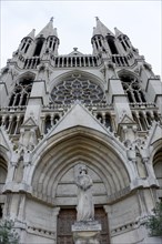 Church of Saint-Vincent-de-Paul, The facade of a Gothic church with detailed sculptures against a