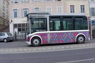 Marseille, A colourful electric bus drives on a city street, Marseille, Departement Bouches du
