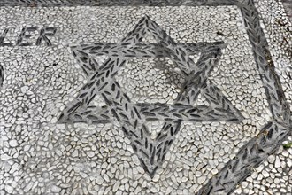 Solabrena, Creative star mosaic design embedded in a pebble pavement, Costa del Sol, Andalusia,