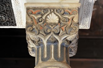 Artistic stone carvings, Alhambra, Granada, detail of a decorated antique column with blue and