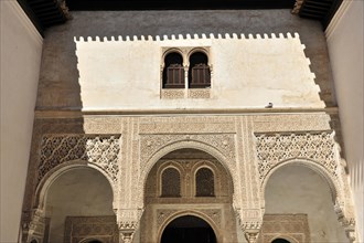 Artistic stone carvings, Alhambra, Granada, View of a Moorish courtyard with ornate arches and