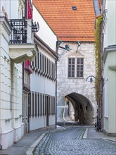Archway at the town hall in the historic old town, alley with cobblestones, Muehlhausen, Thuringia,
