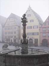 The market square with town houses and St George's Fountain in the historic old town in the morning