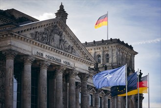 The flag of NATO, Europe and the Federal Republic of Germany photographed at the Reichstag building