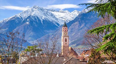 Tower of the parish church with the peak 3006m in the Texel Group in spring, Merano, Val Passiria,
