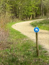 Sign for riders in front of designated signposted bridle path with soft sandy ground leading