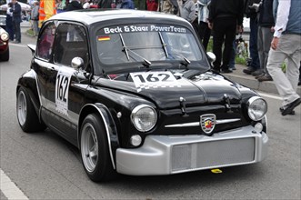 Black classic racing car with number 162 followed by other cars on a road, SOLITUDE REVIVAL 2011,