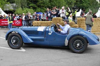 A driver in a blue vintage racing car takes part in a retro event, SOLITUDE REVIVAL 2011,