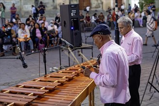 Oaxaca, Mexico, The Marimba del Estado band entertains a crowd in the zocalo. Marimba band music is