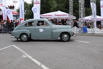 A vintage car drives on a road, watched by spectators, SOLITUDE REVIVAL 2011, Stuttgart,