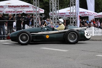 A green vintage racing car with the number 20 drives past spectators, SOLITUDE REVIVAL 2011,