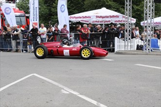 Red racing car with the number 210 drives past enthusiastic fans, SOLITUDE REVIVAL 2011, Stuttgart,