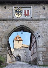 View through the Kobolzell Gate with front gate, Kobolzell Tower and town coat of arms, Rothenburg