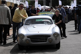 People pushing a classic silver sports car at a racing event, SOLITUDE REVIVAL 2011, Stuttgart,