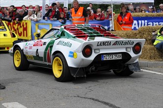 Rear view of a Lancia Stratos rally car surrounded by spectators at a race, SOLITUDE REVIVAL 2011,