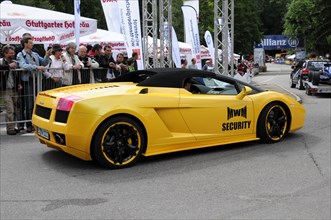 Side view of a yellow Lamborghini sports car with sponsor stickers at a race, SOLITUDE REVIVAL