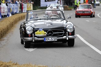 A black Mercedes-Benz classic car during a race with spectators in the background, SOLITUDE REVIVAL