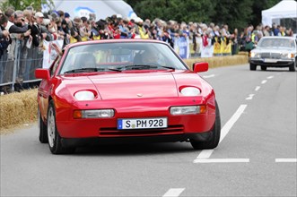 A red Porsch sports car with a modern design takes part in a classic car race, SOLITUDE REVIVAL