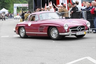 Red Mercedes vintage coupe at a racing event with an audience, SOLITUDE REVIVAL 2011, Stuttgart,