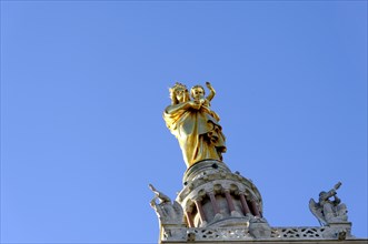 Church of Notre-Dame de la Garde, Marseille, Golden statue with raised hands on cathedral under