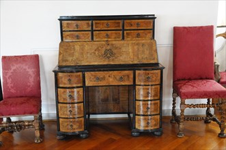 Langenburg Castle, Antique wooden secretary with marquetry, opened up next to elegant chairs,
