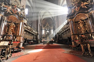 Speyer Cathedral, rays of light fall on the red carpet in a church with baroque sculptures, Speyer