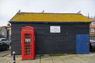 Red former telephone box, shed, seagulls, harbour, Folkestone, Kent, Great Britain