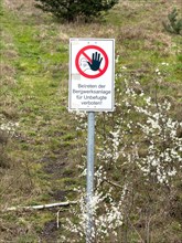 Prohibition sign with logo and inscription Unauthorised persons must not enter the mine site at the