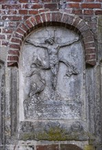 Stone relief of the crucified Christ at St Mary's Cathedral, Havelberg, Saxony-Anhalt, Germany,