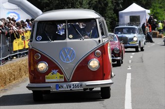 A classic VW T1 bus drives past a crowd of people, SOLITUDE REVIVAL 2011, Stuttgart,