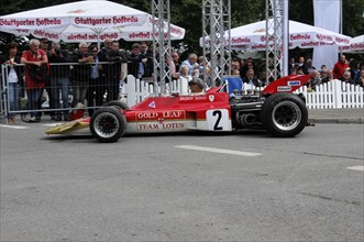 A historic Formula 1 racing car drives past a crowd at a motorsport event, SOLITUDE REVIVAL 2011,
