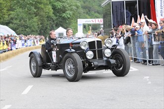 A black vintage racing car drives past a crowd, SOLITUDE REVIVAL 2011, Stuttgart,