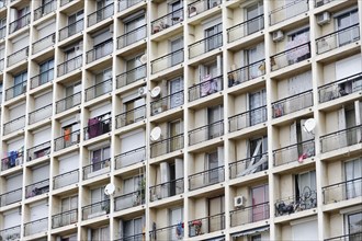 Marseille, Monotonous facade of a large apartment block with many balconies and washing lines,