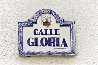 Solabrena, Ceramic street sign 'Calle Gloria' with blue and white lettering and ornaments,