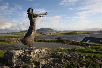 A shot of Niall Bruton's statue, Waiting on the Shore, depicting a woman with arms outstretched in