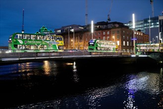 Buses cross the River Liffey at night. Dublin, Ireland, Europe