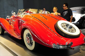 A bright red convertible vintage car at an exhibition, Mercedes-Benz Museum, Stuttgart,