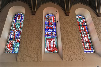 Speyer Cathedral, Colourful stained glass windows next to a wall with relief-like lettering, Speyer
