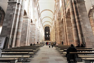 Speyer Cathedral, majestic church interior with people walking between columns and stained glass